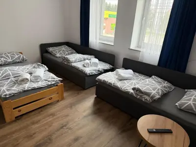 Łóżko lub łóżka w pokoju w obiekcie Hostel Granat