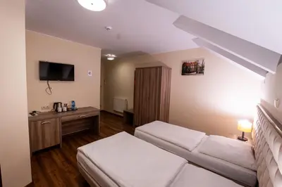 Łóżko lub łóżka w pokoju w obiekcie Zajazd Pod Borem