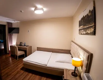Łóżko lub łóżka w pokoju w obiekcie Zajazd Pod Borem