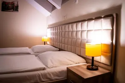 Łóżko lub łóżka w pokoju w obiekcie Zajazd Pod Borem