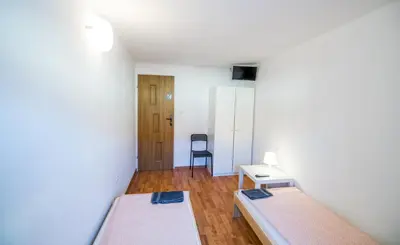Łóżko lub łóżka w pokoju w obiekcie Noclegi WOKU