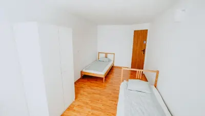 Łóżko lub łóżka w pokoju w obiekcie Noclegi WOKU