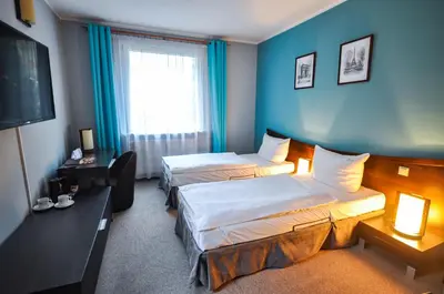 Łóżko lub łóżka w pokoju w obiekcie Hotel Trzy Światy Spa & Wellness Rajska WySpa