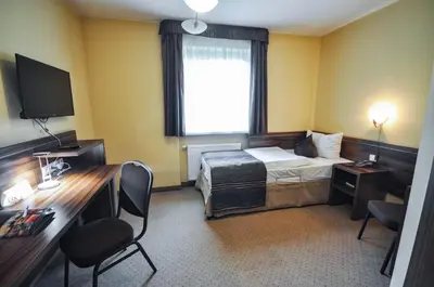 Łóżko lub łóżka w pokoju w obiekcie Hotel Trzy Światy Spa & Wellness Rajska WySpa