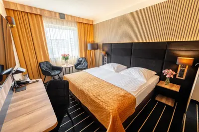 Łóżko lub łóżka w pokoju w obiekcie Park Hotel Diament Wroclaw