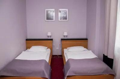 Łóżko lub łóżka w pokoju w obiekcie Hotel Sękowski