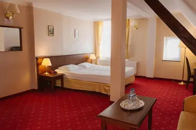 Łóżko lub łóżka w pokoju w obiekcie Hotel Jakub Sobieski