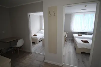 Łóżko lub łóżka w pokoju w obiekcie Pod Kominem Pokoje i Apartamenty