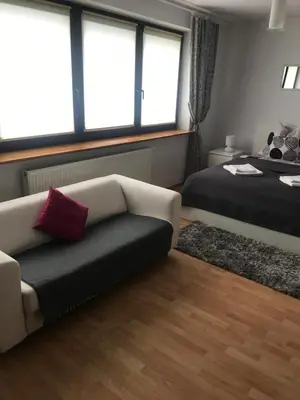 Łóżko lub łóżka w pokoju w obiekcie APARTAMENT Zakątek Wrocławia