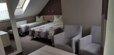 Łóżko lub łóżka w pokoju w obiekcie Zajazd Tytan