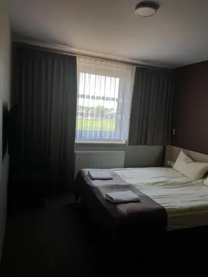 Łóżko lub łóżka w pokoju w obiekcie Zajazd Tytan
