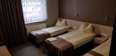 Łóżko lub łóżka w pokoju w obiekcie Zajazd Tytan