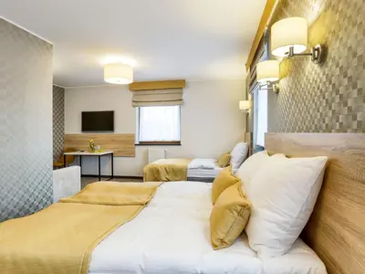 Łóżko lub łóżka w pokoju w obiekcie Hotel Antek
