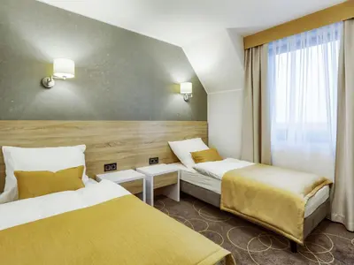 Łóżko lub łóżka w pokoju w obiekcie Hotel Antek