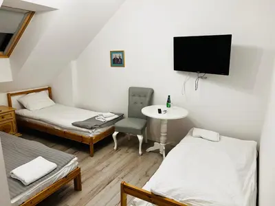 Łóżko lub łóżka w pokoju w obiekcie Piławski Dwór