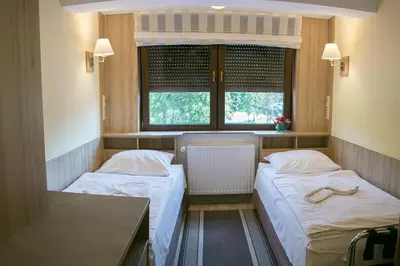 Łóżko lub łóżka w pokoju w obiekcie Hotel Korona