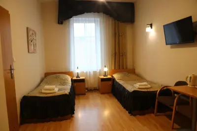 Łóżko lub łóżka w pokoju w obiekcie Dom Wypoczynkowy HALKA Kudowa-Zdrój w górach