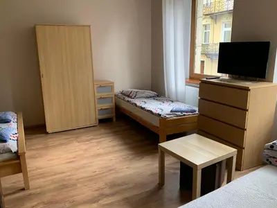 Łóżko lub łóżka w pokoju w obiekcie Apartamenty pokoje 