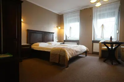 Łóżko lub łóżka w pokoju w obiekcie Hotel Alexandra