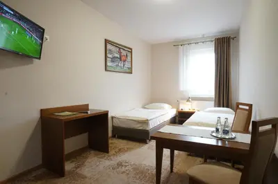 Łóżko lub łóżka w pokoju w obiekcie Hotel Alexandra