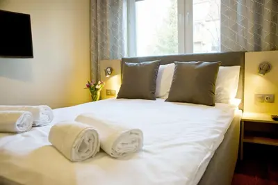 Łóżko lub łóżka w pokoju w obiekcie Apartament Fryderyk Premium 2