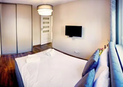 Łóżko lub łóżka w pokoju w obiekcie Apartament Fryderyk Premium 2
