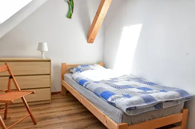 Łóżko lub łóżka w pokoju w obiekcie Trzy Siostry