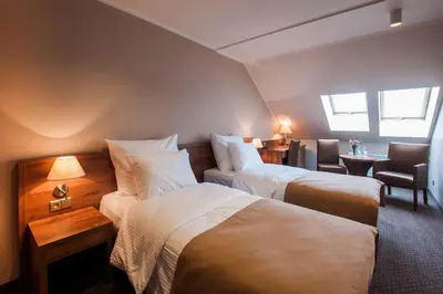 Łóżko lub łóżka w pokoju w obiekcie Hotel Gem