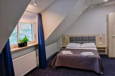Łóżko lub łóżka w pokoju w obiekcie Hotel Podjadek
