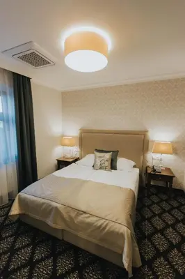Łóżko lub łóżka w pokoju w obiekcie HG Hotel