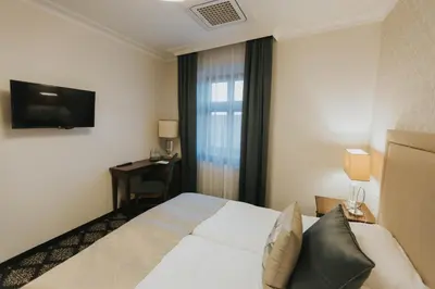 Łóżko lub łóżka w pokoju w obiekcie HG Hotel