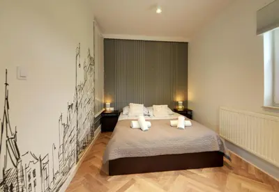 Łóżko lub łóżka w pokoju w obiekcie Q Apartamenty