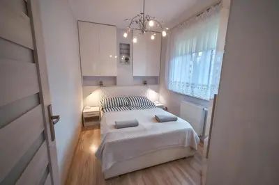 Łóżko lub łóżka w pokoju w obiekcie Apartament Willa Ogrodowa 18