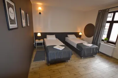 Łóżko lub łóżka w pokoju w obiekcie SleepZone Apartments