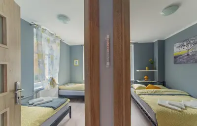 Łóżko lub łóżka w pokoju w obiekcie Apartament Grosik