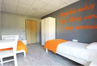 Łóżko lub łóżka w pokoju w obiekcie Dom Sportowca