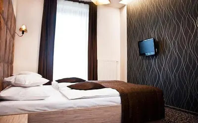 Łóżko lub łóżka w pokoju w obiekcie Hotel Vis A Vis