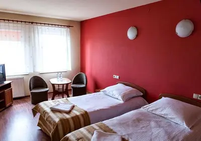Łóżko lub łóżka w pokoju w obiekcie Hotel Omega