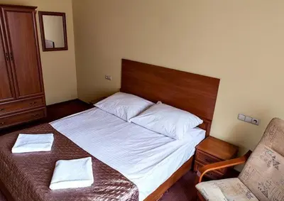 Łóżko lub łóżka w pokoju w obiekcie Hotel Omega