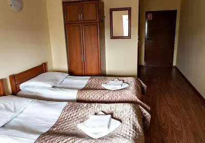 Łóżko lub łóżka w pokoju w obiekcie Hotel Omega