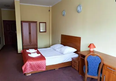 Łóżko lub łóżka w pokoju w obiekcie Hotel Omega