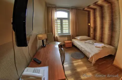 Łóżko lub łóżka w pokoju w obiekcie Hotel Polonia