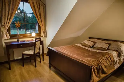 Łóżko lub łóżka w pokoju w obiekcie Pensjonat Enklawa