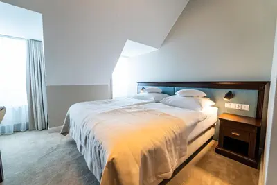 Łóżko lub łóżka w pokoju w obiekcie Hotel Piast