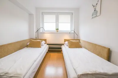 Łóżko lub łóżka w pokoju w obiekcie Apartamenty w Parku Leśnym ul Cicha 1 - PolanicaApartamenty pl