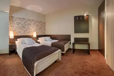 Łóżko lub łóżka w pokoju w obiekcie Hotel Zacisze