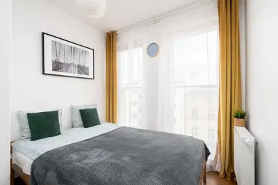 Łóżko lub łóżka w pokoju w obiekcie A.S. HOME Kościuszki Apartament dwupoziomowy