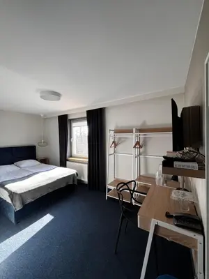 Łóżko lub łóżka w pokoju w obiekcie Hotel Marta