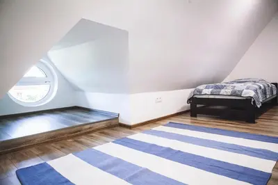 Łóżko lub łóżka w pokoju w obiekcie Villa Tower Nad Jeziorem Nyskim