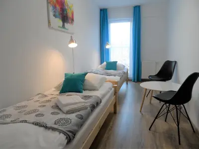 Łóżko lub łóżka w pokoju w obiekcie Apartament Dmowskiego - Kępa Mieszczańska